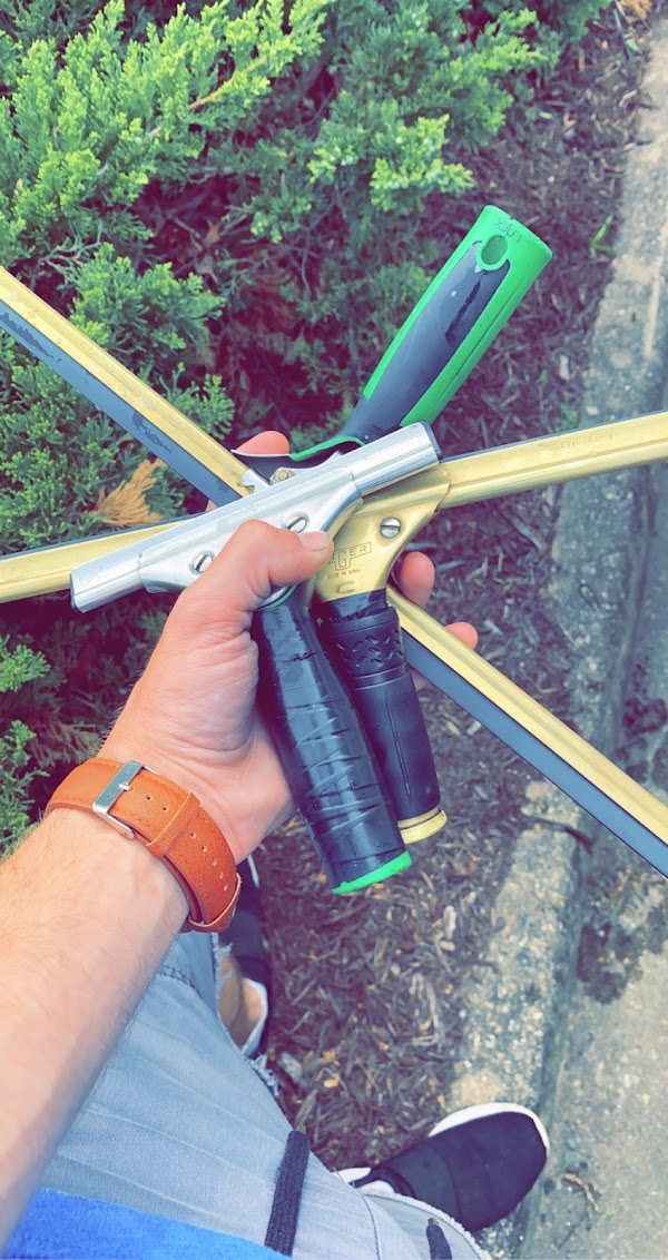 Professional window cleaning squeegee tools in hand