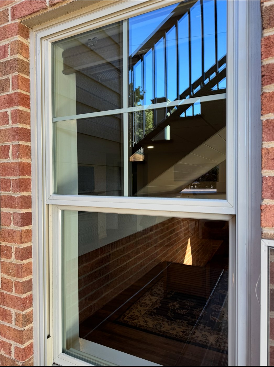 Clean residential window reflection with crisp glass and frame detail