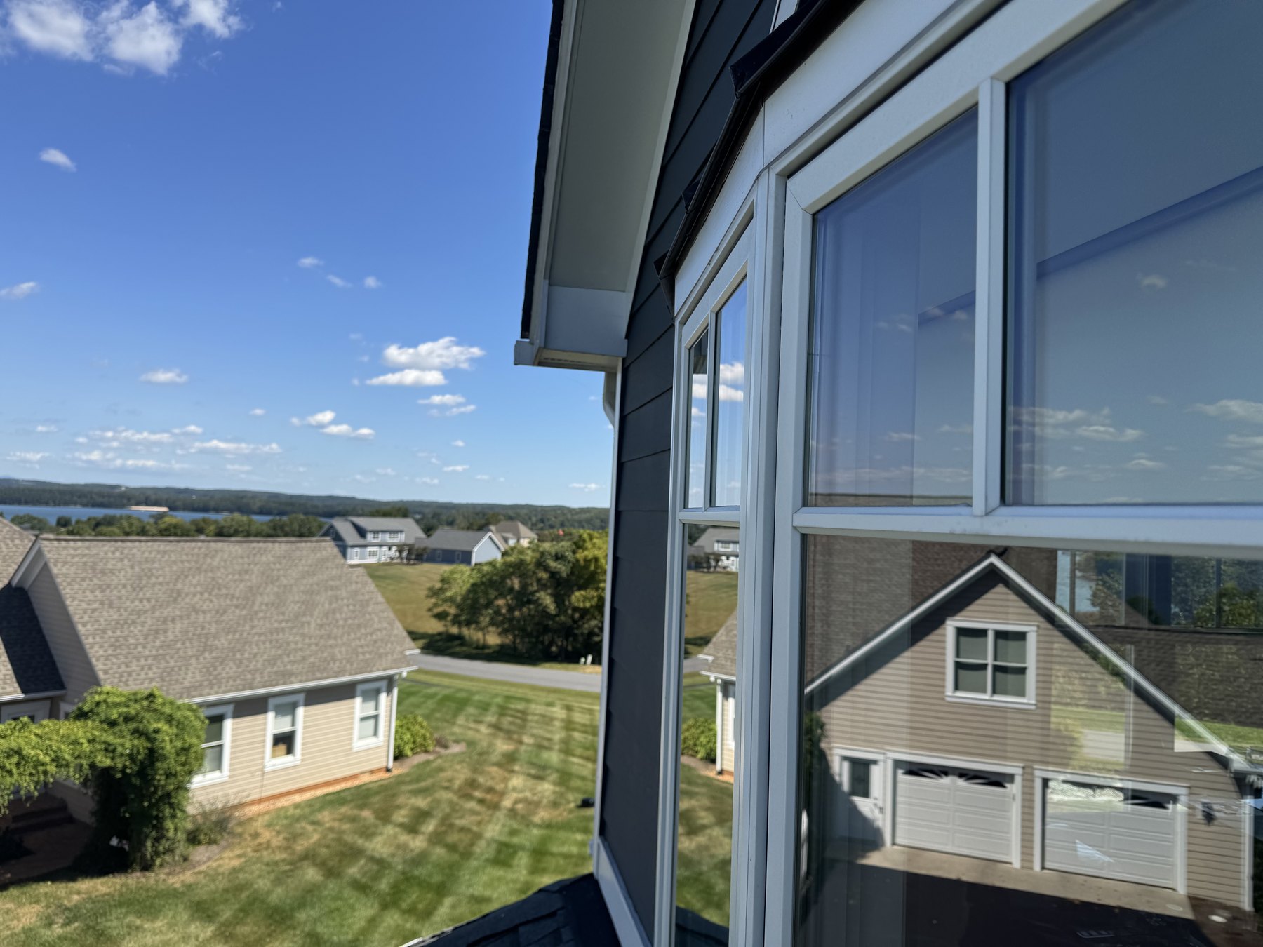 Spotless lake home window glass with clear outdoor reflection